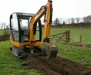 Excavator digging trench